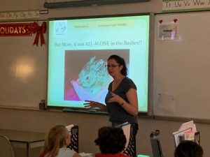 Debra delivering a wildlife presentation to a classroom of students